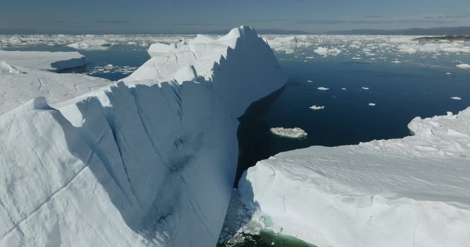 Aerial view of large iceberg in water