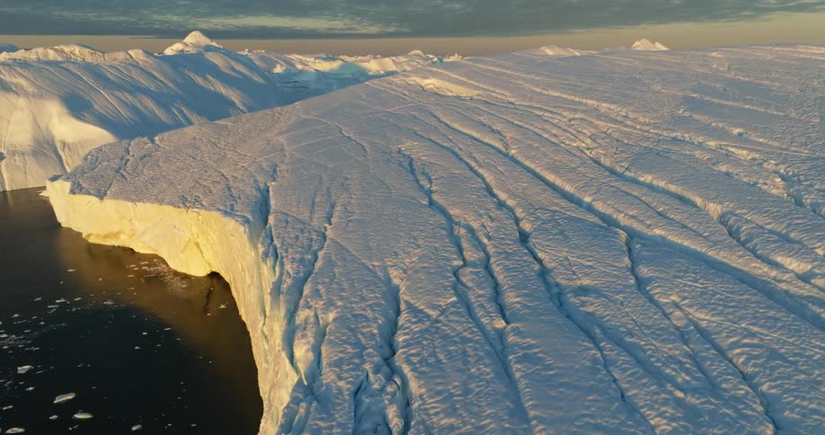 Aerial view of large glacier at sunset