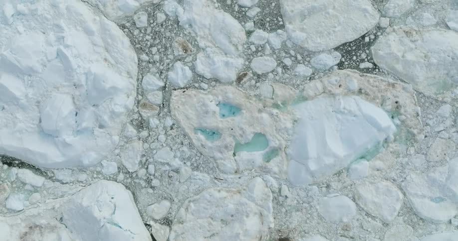 An aerial view of rock formations with ponds