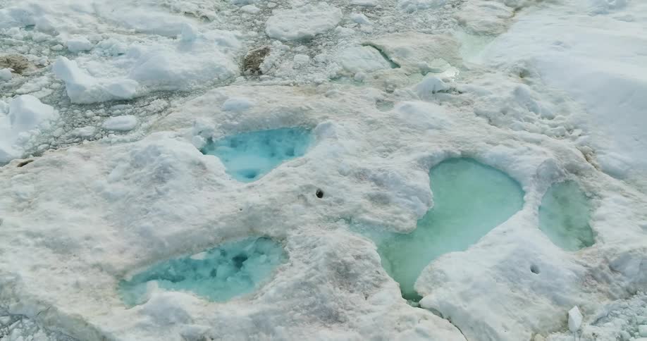 Clear blue water lakes are in a snow covered mountain area