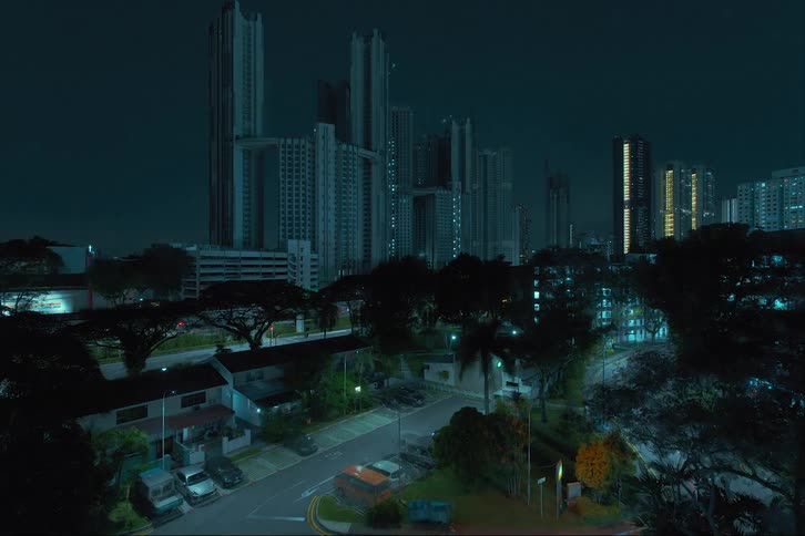 A time lapse of cars pulling in and out of parking spaces in front of homes with the city skyline lighting up in the distance