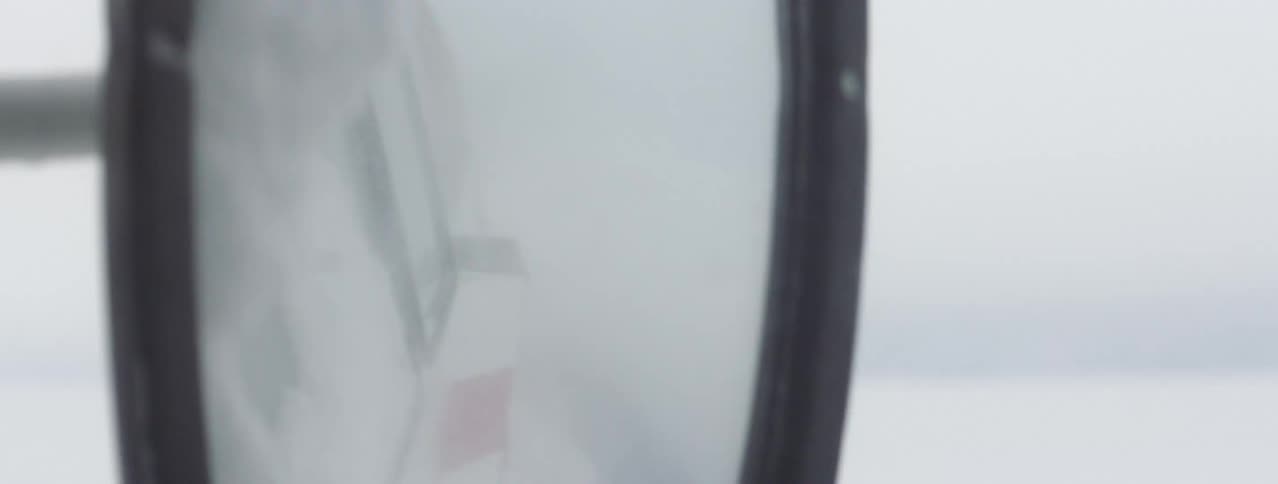 A truck is driving in the snow