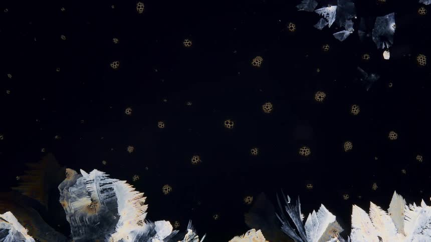 A graphic design mimics the spread of smoke and cracked glass on a dark surface