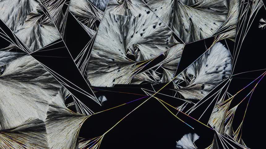 a complex crystal texture grows under a microscope