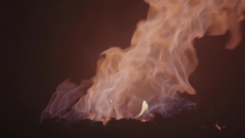Fire burns in a dark area