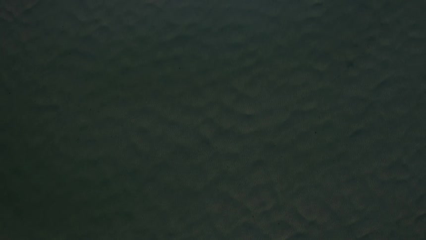 Waves below move towards a small island