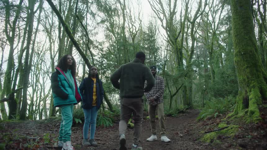 A teenager jumps into the woods to join his friends