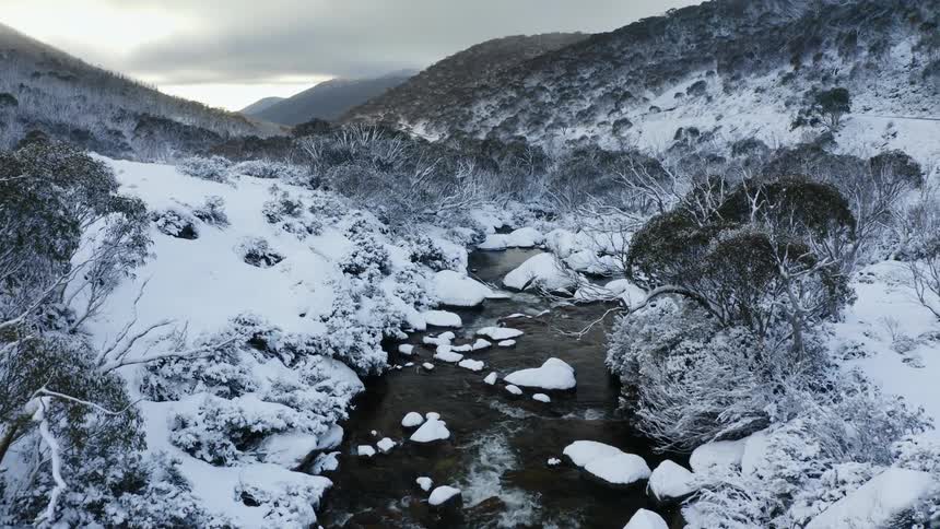 An aerial view of a mountain covered in snow