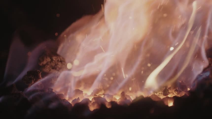A fire burns and throws off sparks