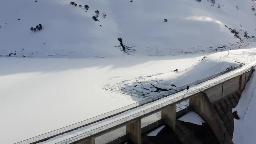 A person is walking on a bridge in an arctic area