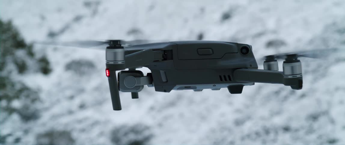 Drone flying over snowy slope