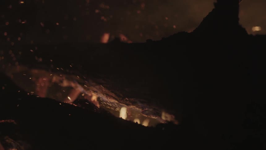 Hot embers float up from burning branches