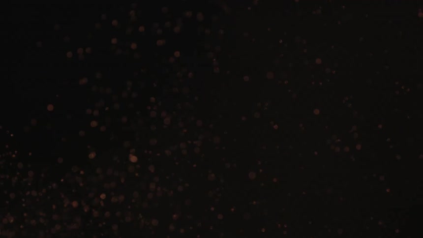 Burning embers floating into the night sky
