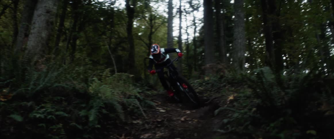 A man is riding his mountain bike downhill