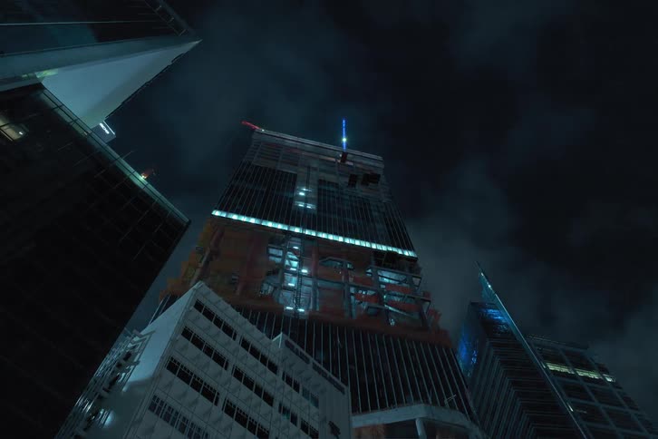 A skyscraper being constructed floor by floor at night