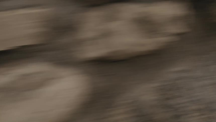 Vehicle driving by stone wall