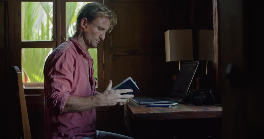 A man types his passport information into the laptop