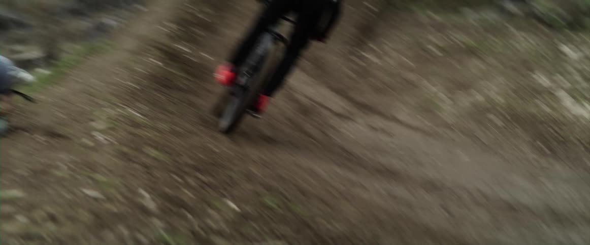 A man jumps over a hill on a mountain bike