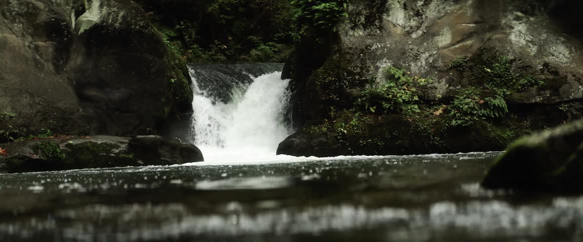 A waterfall crashing in to a river