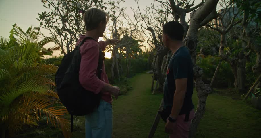 Man talks to another and shakes hands before asking for directions