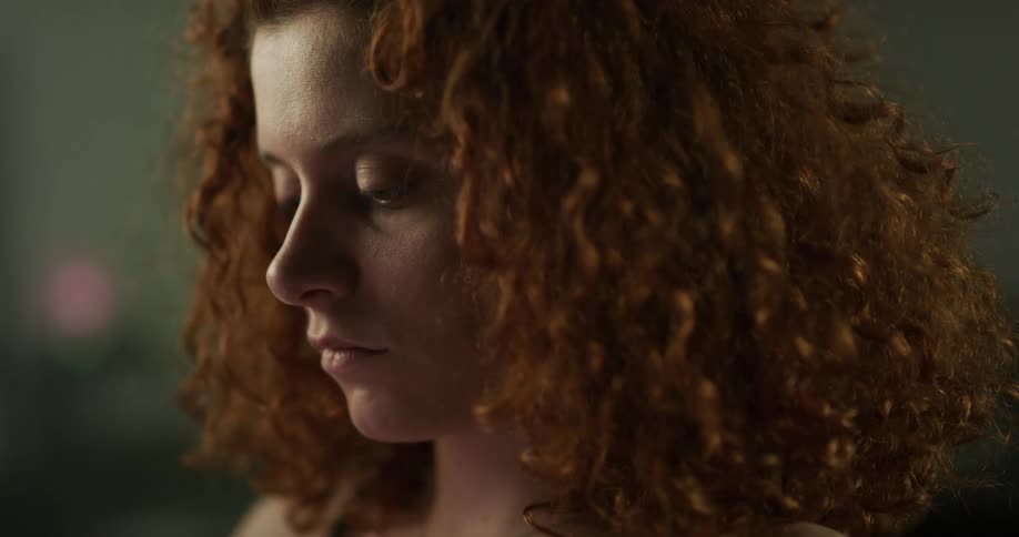 A red headed woman with curly hair