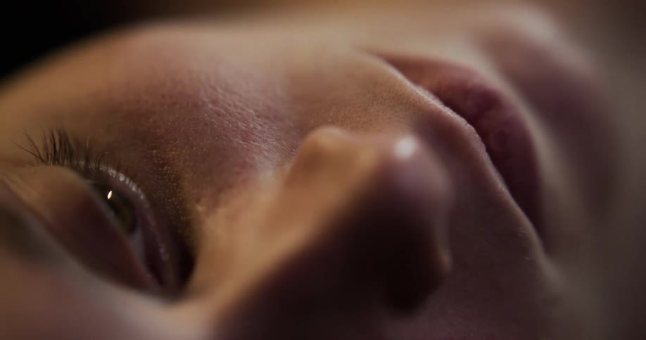 Close up of the face of a woman resting on the floor