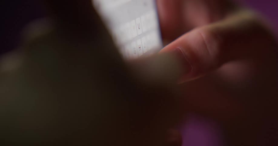 Close up of the hands of a woman texting on her smartphone