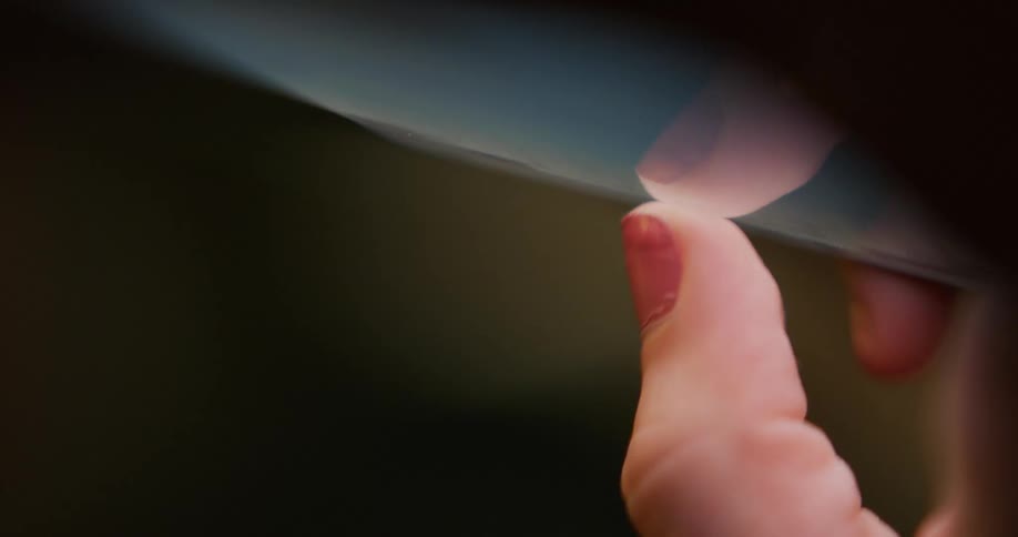 Close up of the hands of a woman texting on her smartphone