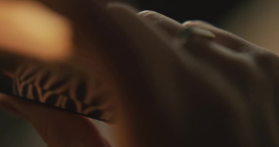 Person watches movie on smartphone
