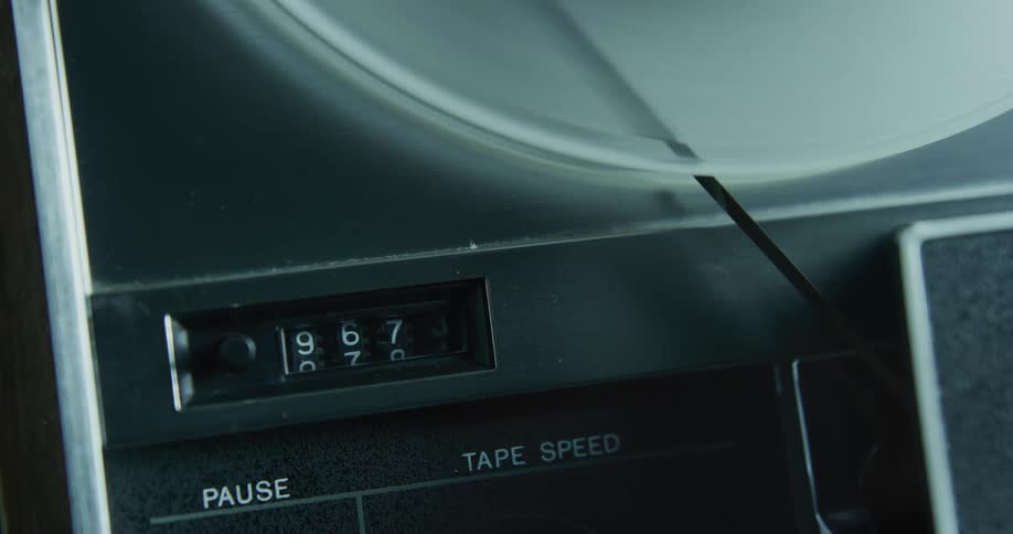 Numbers change as the wheel spins on an old reel to reel tape player
