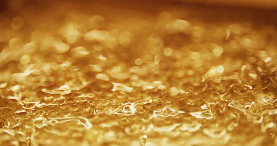 Golden honey shimmering and dripping