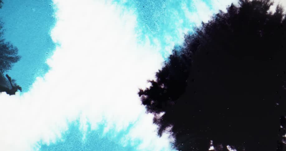 Splotches of color fall onto surface and spread
