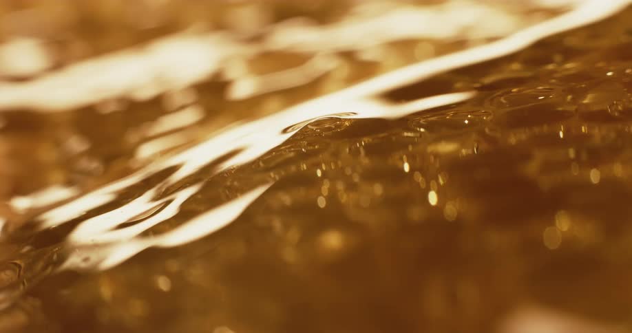 Close up of honeycomb and honey flowing down