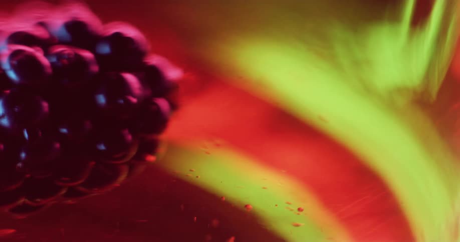 Purple grape light cluster moves through translucent fluid with yellow and orange background