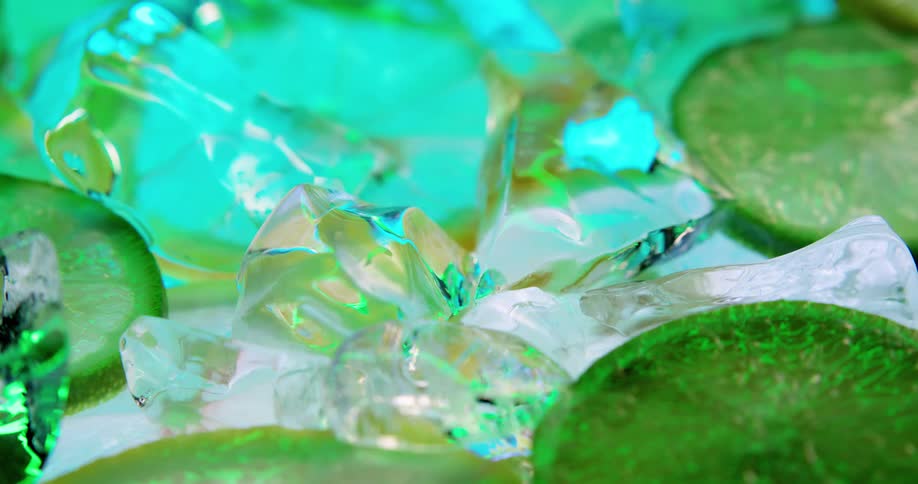 Lemon and lime slices surrounded by chipped ice floating on the surface of a drink