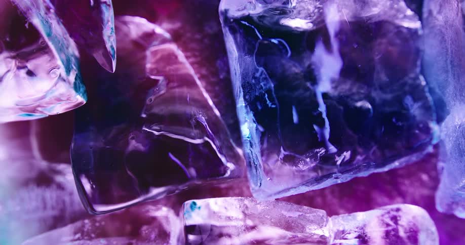 Colorful light reflects on the surface of ice cubes