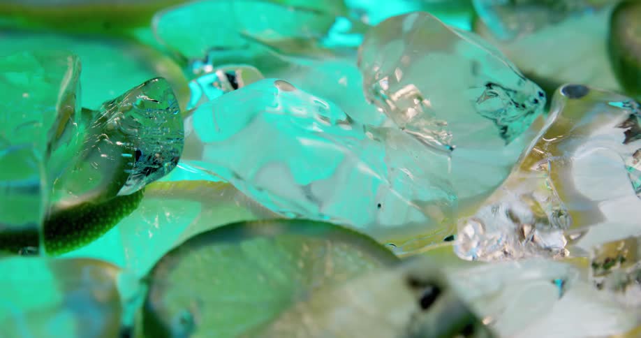 A group of small ice sculptures and cubes slowly spins showing intricately carved pieces