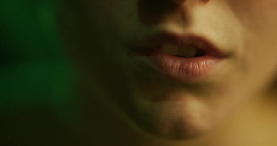 Woman with submerged face moves her mouth
