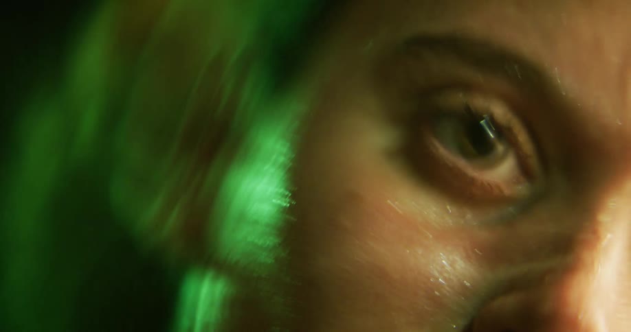 Ripples and water reflected light move over womans eye shown in water