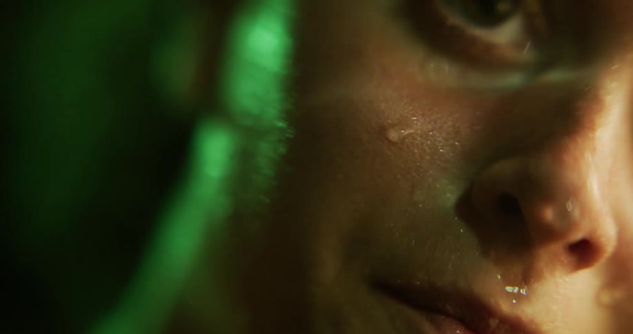 A sad and depressed looking woman is shown very close up as the camera moves from her mouth to her eyes
