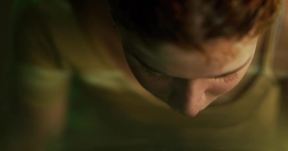 Light reflecting off the water surface plays across a womans face