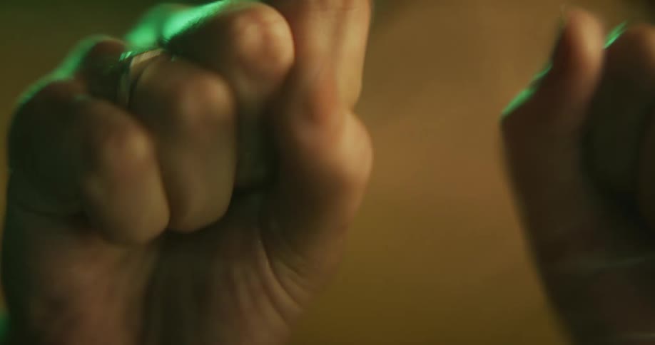 Close up of a womans hands as she squeezes them shut and opens them
