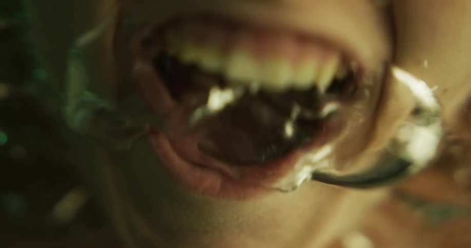 A woman laughs before sticking her face underwater and screaming