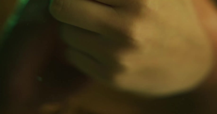 A woman clasps her hands together in the water