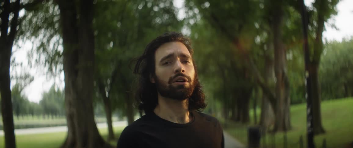 A man takes deep breaths while standing on a bike path
