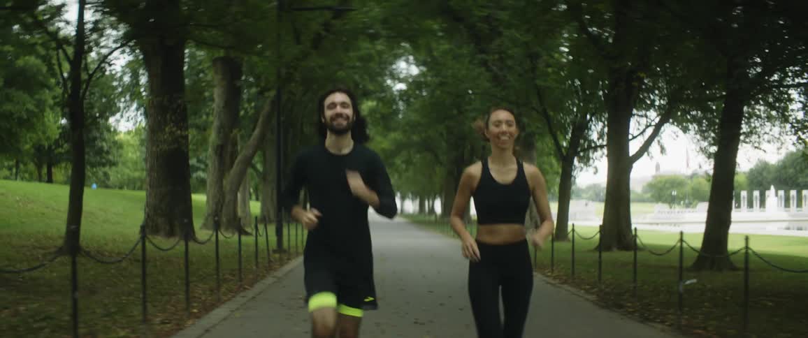 A man and woman are jogging together