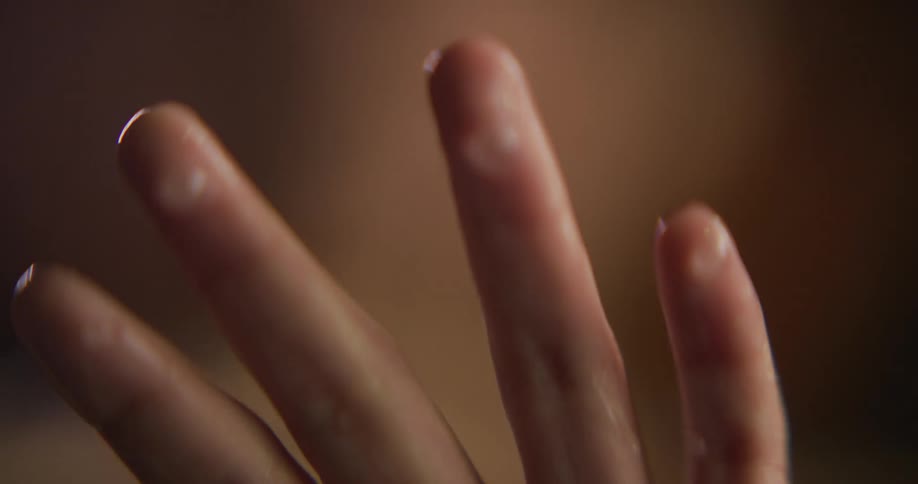 Hands swirling and moving through clear water