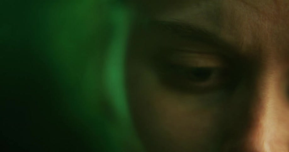 A womans face is underwater and her eyes and mouth are open but she is not moving