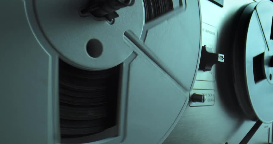 The reels on a reel to reel tape player are turning
