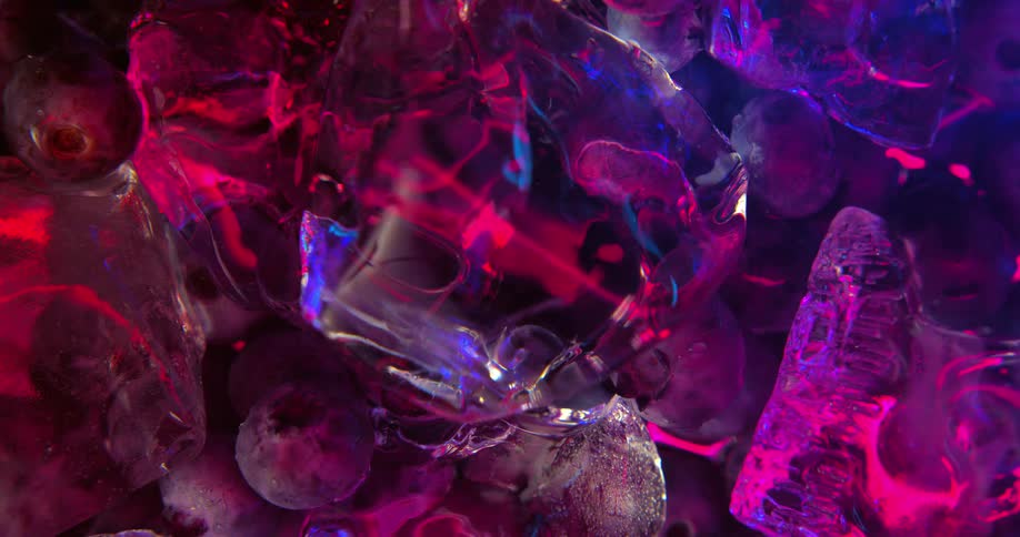 Colorful neon lights reflecting on ice floating in water